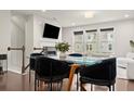 Modern dining area featuring a glass table, velvet chairs, and views of a bright living space at 2452 Coosa Vly, Atlanta, GA 30339