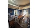 Dining room with long wooden table, patterned rug, and view into the entry at 3740 Tupelo Trl, Auburn, GA 30011
