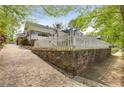 Street view showing brick home with retaining wall and sidewalk in the foreground at 1626 Rogers Sw Ave, Atlanta, GA 30310