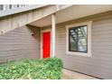 The unit's door is bright red, surrounded by gray vinyl siding and manicured green bushes at 2930 Torreya Se Way, Marietta, GA 30067