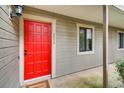 Front entrance has a bright red door on a gray-sided unit with manicured landscaping at 2930 Torreya Se Way, Marietta, GA 30067