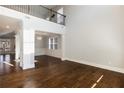 Open-concept living room with hardwood floors, grand windows, high ceilings, and elegant chandelier at 5255 Austrian Pine Ct, Cumming, GA 30040