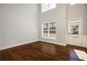 Bright living room with hardwood floors, and large windows allowing ample natural light at 5255 Austrian Pine Ct, Cumming, GA 30040