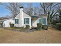 Quaint white brick home with blue shutters, covered entry, and well-maintained landscaping at 1322 Lorenzo Sw Dr, Atlanta, GA 30310