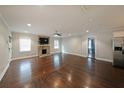 Spacious living room features a stone fireplace, hardwood floors, and bright natural light at 1322 Lorenzo Sw Dr, Atlanta, GA 30310