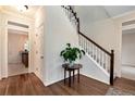 Inviting foyer features hardwood floors, staircase with white railings, and view into the kitchen at 2691 Jamerson Rd, Marietta, GA 30066