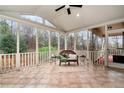 Relaxing screened-in patio featuring tile floors, a comfortable seating area, and wooded views at 2691 Jamerson Rd, Marietta, GA 30066