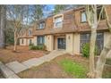 Well-maintained condominium featuring a peaked roof, mature landscaping, and inviting entrance at 3100 Parc Lorraine, Lithonia, GA 30038