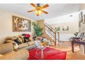 Cozy living room featuring a ceiling fan, hardwood floors, and staircase at 4270 Holliday Rd, Atlanta, GA 30349