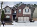 Charming two-story brick home with a well-manicured front lawn and attached two-car garage at 868 Still Hill Ln, Lawrenceville, GA 30045
