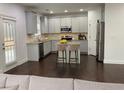 Stylish kitchen with stainless steel appliances, granite counters, and central island at 868 Still Hill Ln, Lawrenceville, GA 30045