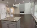Bright open concept living room featuring a modern fireplace and hardwood floors at 868 Still Hill Ln, Lawrenceville, GA 30045