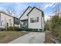 View of renovated home featuring a driveway and manicured landscaping at 139 Dahlia Nw Ave, Atlanta, GA 30314