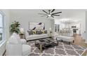 Bright living room featuring modern decor, a ceiling fan, and an open floor plan at 139 Dahlia Nw Ave, Atlanta, GA 30314