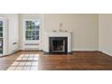 Inviting living room with beautiful hardwood floors, large windows, and a classic fireplace at 2836 Alpine Ne Rd, Atlanta, GA 30305