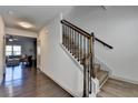 Hallway features hardwood floors, access to the living room, and a staircase with dark banister at 1676 Charcoal Ives Rd, Lawrenceville, GA 30045