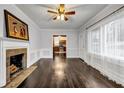 Cozy living room features a fireplace, hardwood floors, wainscoting, and large windows at 1747 Parkhill Dr, Decatur, GA 30032