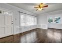 Bright living room boasts hardwood floors, wainscoting, large windows, and neutral paint at 1747 Parkhill Dr, Decatur, GA 30032