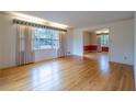 Spacious living room featuring gleaming hardwood floors, large windows and detailed trim work at 1958 Starfire Ne Dr, Atlanta, GA 30345