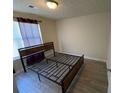 A bedroom featuring vinyl floors and window with dark curtains at 5301 Fairington Club Dr, Lithonia, GA 30038