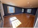 Bright bedroom with hardwood floors, three windows with plantation shutters, crown molding, and plenty of natural light at 6542 Cherry Tree Ln, Atlanta, GA 30328