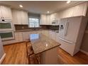 Modern kitchen features stainless steel appliances, granite countertops, a kitchen island and white cabinetry at 6542 Cherry Tree Ln, Atlanta, GA 30328