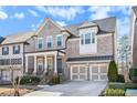 Traditional brick home featuring a two-car garage and welcoming front porch at 11330 Easthaven Pl, Johns Creek, GA 30097