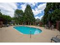 Relaxing pool area with lounge chairs and tables, perfect for outdoor enjoyment at 1406 Winston Pl, Decatur, GA 30033