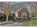 Attractive red brick house with mature trees and landscaped front yard at 1406 Winston Pl, Decatur, GA 30033