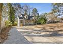 Attractive property showcasing professional landscaping, neutral paint, and an expansive driveway at 1824 Westwood Sw Ave, Atlanta, GA 30310