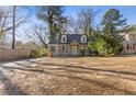 Quaint two-story home boasting a large front yard, updated siding, and a welcoming entrance at 1824 Westwood Sw Ave, Atlanta, GA 30310