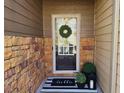 Cozy front door entrance with decorative wreath, striped rug and potted plants at 2613 Stonekey Bnd, Lithonia, GA 30058