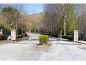 Gated entrance to the community with brick pillars and wrought iron fencing, ensuring privacy and security at 2613 Stonekey Bnd, Lithonia, GA 30058