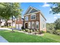 Beautiful brick home with manicured lawn and trimmed hedges on a sunny day at 4335 Hastings Dr, Cumming, GA 30041