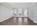 Bright living room featuring hardwood floors, fresh gray paint, and large window at 4335 Hastings Dr, Cumming, GA 30041