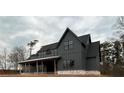 Stylish new construction showcasing dark siding, black framed windows, and architectural details at 157 Palisade Dr, Rydal, GA 30171