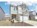 Charming two-story home featuring modern siding, a brick foundation, and a two-car garage at 2778 Aralynn Way, College Park, GA 30337