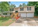 Inviting two-story home featuring a brick facade, double garage, and freshly painted exterior at 467 Pineburr Ln, Stone Mountain, GA 30087