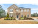 Charming two-story brick home with manicured landscaping on a well-maintained lawn at 1305 Lanier Ct, Hampton, GA 30228