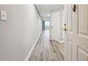 Bright condo hallway with gray walls and wood-look flooring leading to a balcony at 1501 Clairmont Rd # 1624, Decatur, GA 30033