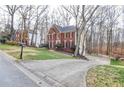 Brick home with well-kept lawn, long driveway and classic black mailbox at 1975 Skidmore Cir, Lawrenceville, GA 30044