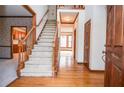 Welcoming foyer with hardwood floors, staircase, and traditional wood trim throughout at 1975 Skidmore Cir, Lawrenceville, GA 30044