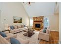 Staged living room showcasing the stone fireplace, hardwood floors and furniture at 241 The Esplanade Se Way, Loganville, GA 30052