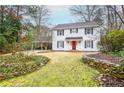 Lovely two-story home with black shutters, covered carport, and a well-maintained front yard at 970 Winding Creek Trl, Atlanta, GA 30328