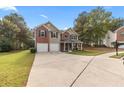 Inviting two-story home boasting a spacious driveway, attached two-car garage, and covered front porch at 1925 Barnett West Ct, Buford, GA 30518