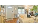 Cozy living room with a white sofa, area rug, wood floors, and a view into the dining area at 368 Lambeth Dr, Hiram, GA 30141