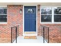 Charming blue front door with decorative glass and black hardware, flanked by sidelight windows and a small step at 412 E Pharr Rd, Decatur, GA 30030