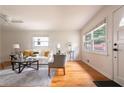 Bright living room with hardwood floors, a ceiling fan, large windows, and stylish furniture creating a cozy atmosphere at 412 E Pharr Rd, Decatur, GA 30030
