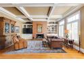 Cozy living room featuring a brick fireplace, built-in shelves, and comfortable leather furniture at 195 High Bluff Ct, Duluth, GA 30097