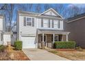 Two-story home boasting an attached garage, tidy front yard, and covered entrance at 5545 Mountain Top Pl, Cumming, GA 30041